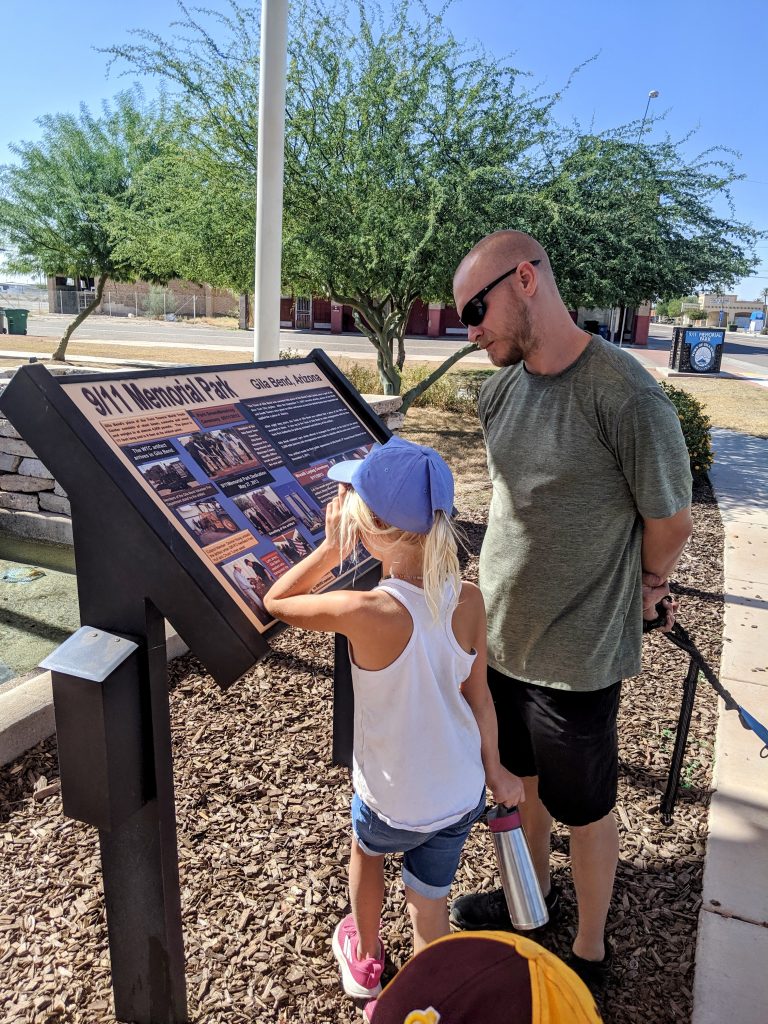 RV dad and daughter learning about 9/11 at a memorial park, using travel moments to teach Memorial Day values