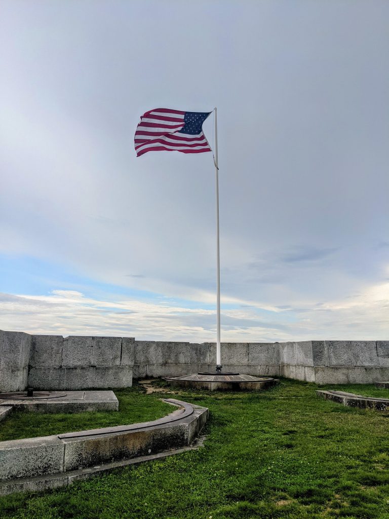 American flag flying over a national cemetery, viewed during a Memorial Day stop by a full-time RV family