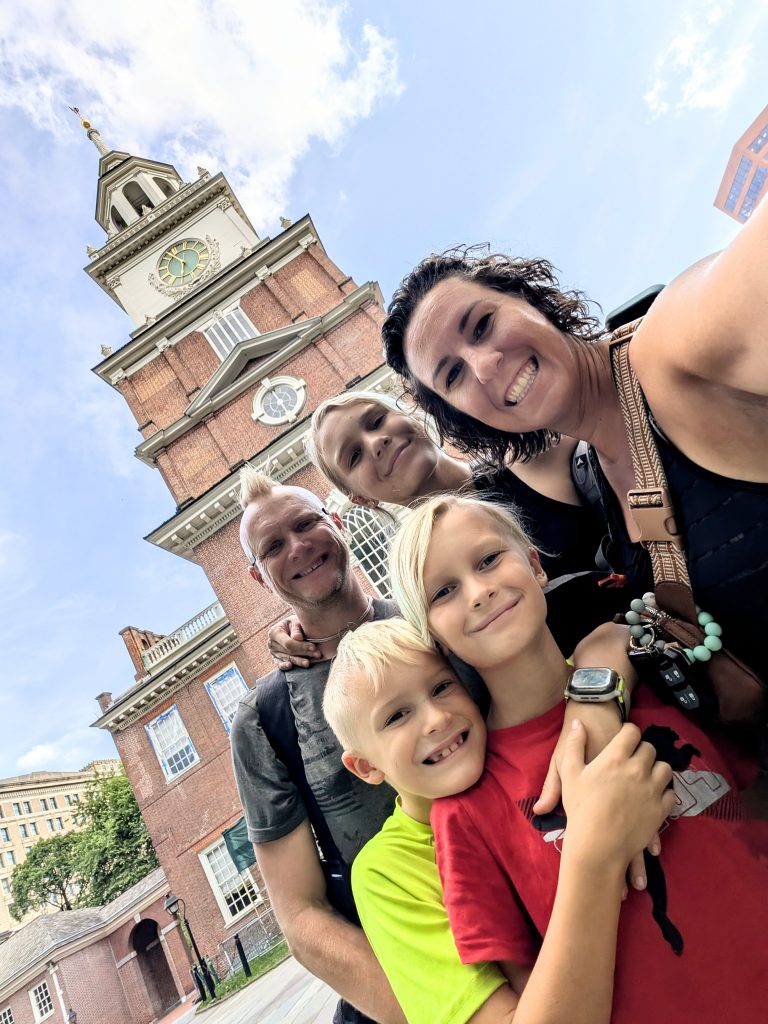 Family selfie in front of Independence Hall during Philadelphia RV trip
